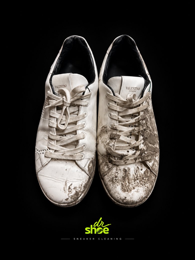 White Valentino sneakers splattered with dried mud, before cleaning at Dr Shoe